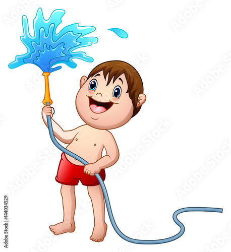 Little boy playing with the water hose