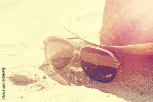 Summer or Vacation Concept. Beautiful Sunglasses with Straw Hat on Sand. Beach. Lifestyle.