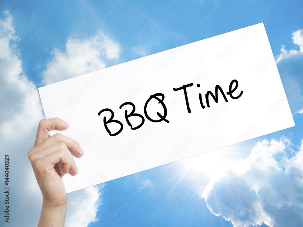 BBQ Time Sign on white paper. Man Hand Holding Paper with text. Isolated on sky background BBQ Time Sign on white paper. Man Hand Holding Paper with text. Isolated on sky background