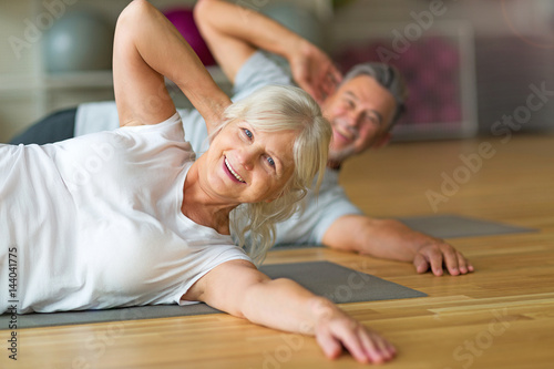 Mature couple doing fitness exercises © pikselstock