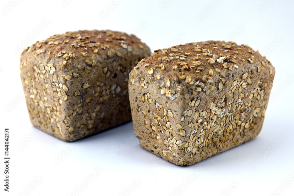 Two loaves of rye bread isolated on white background