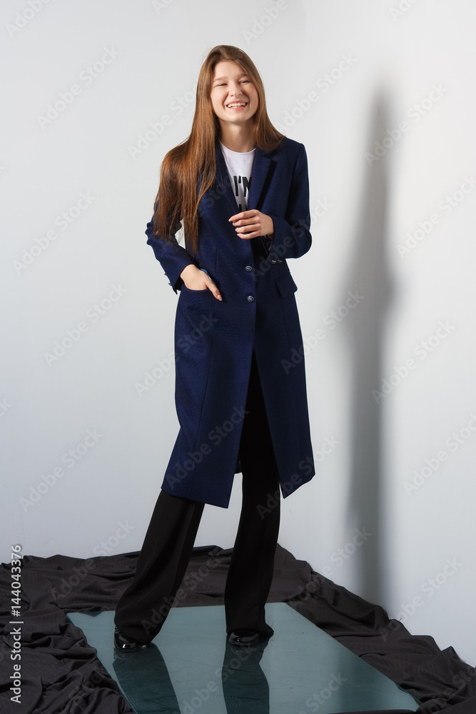 Attractive fashion model girl in wide pants and long coat over t-shirt.  Street style. Stock Photo | Adobe Stock