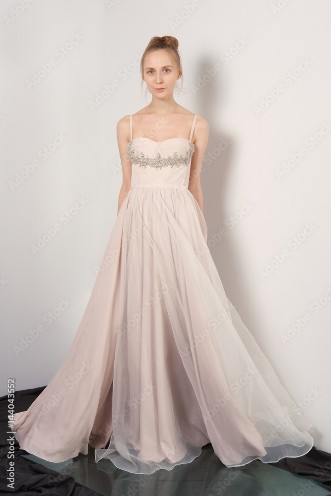 Fantastic fashion woman in fluttering beige dress Fantastic fashion woman in fluttering beige dress