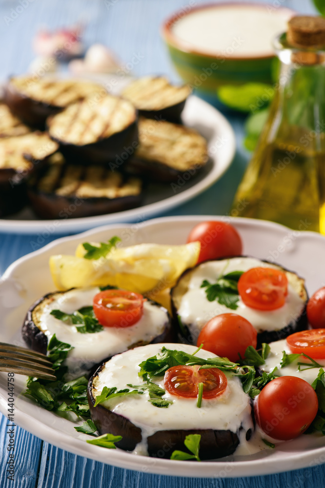 Grilled eggplants with yogurt dip and tomatoes. Grilled eggplants with yogurt dip and tomatoes.