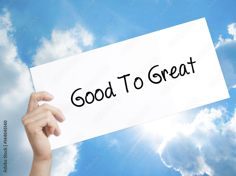 Good To Great Sign on white paper. Man Hand Holding Paper with text. Isolated on sky background Good To Great Sign on white paper. Man Hand Holding Paper with text. Isolated on sky background