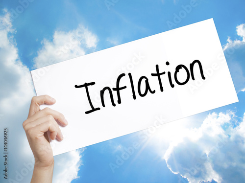 Inflation Sign on white paper. Man Hand Holding Paper with text. Isolated on sky background.