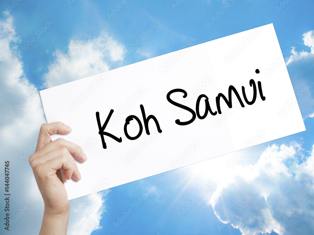 Koh Samui Sign on white paper. Man Hand Holding Paper with text. Isolated on sky background Koh Samui Sign on white paper. Man Hand Holding Paper with text. Isolated on sky background