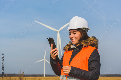 Young female specialist with smartphone photo