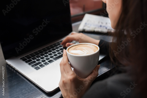 Rear view of a creative female freelancer sitting front laptop