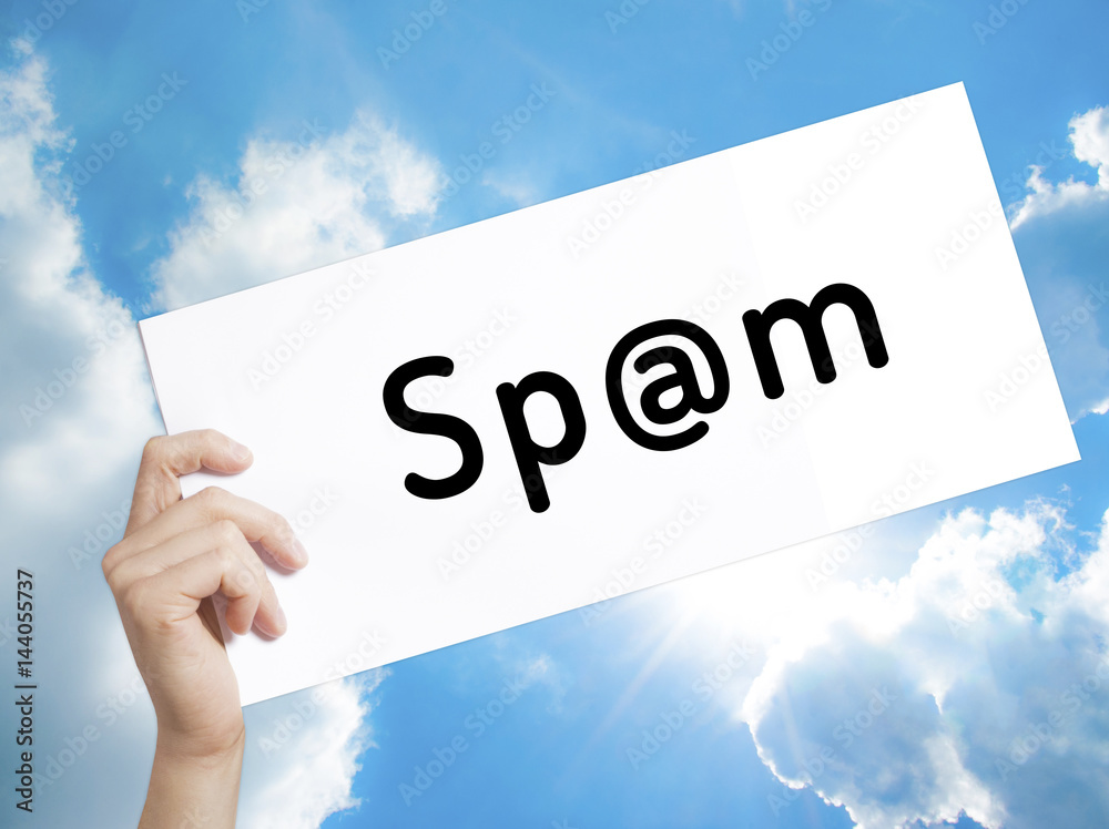 Spam Sign on white paper. Man Hand Holding Paper with text. Isolated on sky background Spam Sign on white paper. Man Hand Holding Paper with text. Isolated on sky background