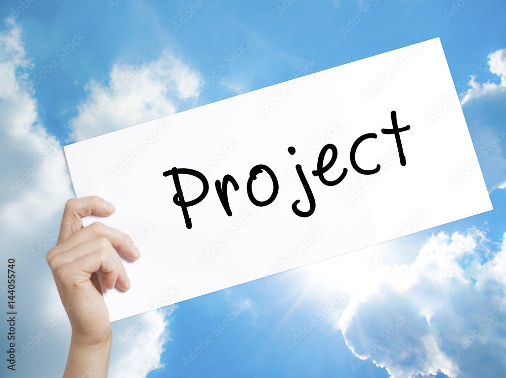 Project Sign on white paper. Man Hand Holding Paper with text. Isolated on sky background Project Sign on white paper. Man Hand Holding Paper with text. Isolated on sky background