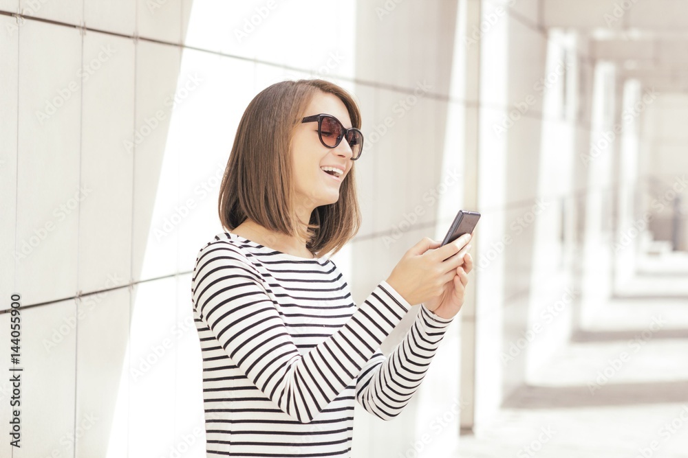 Young woman using mobile phone outdoors Young woman using mobile phone outdoors