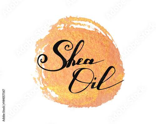 Hand written words Shea Oil on golden paint splash on white background