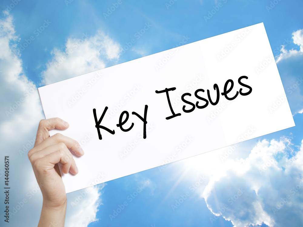 Key Issues Sign on white paper. Man Hand Holding Paper with text. Isolated on sky background Key Issues Sign on white paper. Man Hand Holding Paper with text. Isolated on sky background