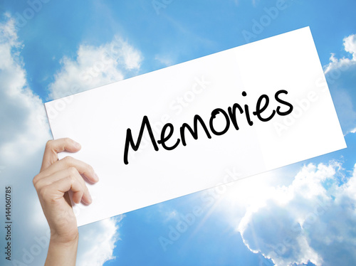 Memories Sign on white paper. Man Hand Holding Paper with text. Isolated on sky background