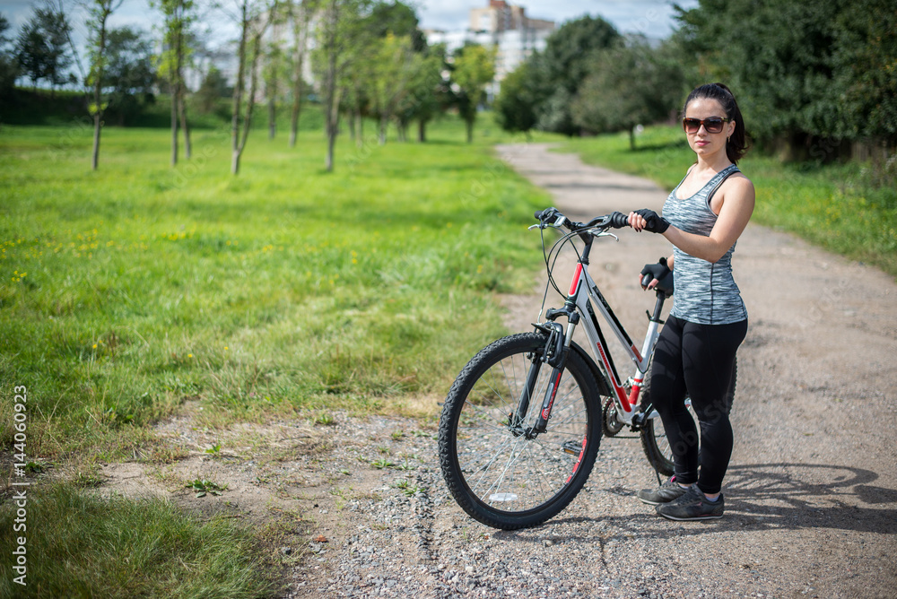 A girl riding a bicycle in a park for sports