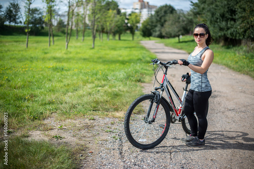 A girl riding a bicycle in a park for sports