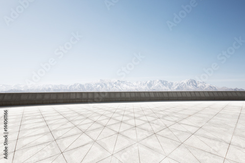 empty brick floor with white snow mountain