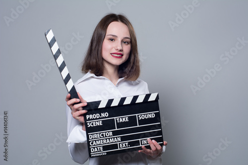 Smiling brunette in white blouse with movie crackers photo