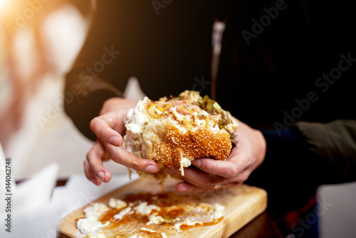 Delicious burger eating fast food. Street food.