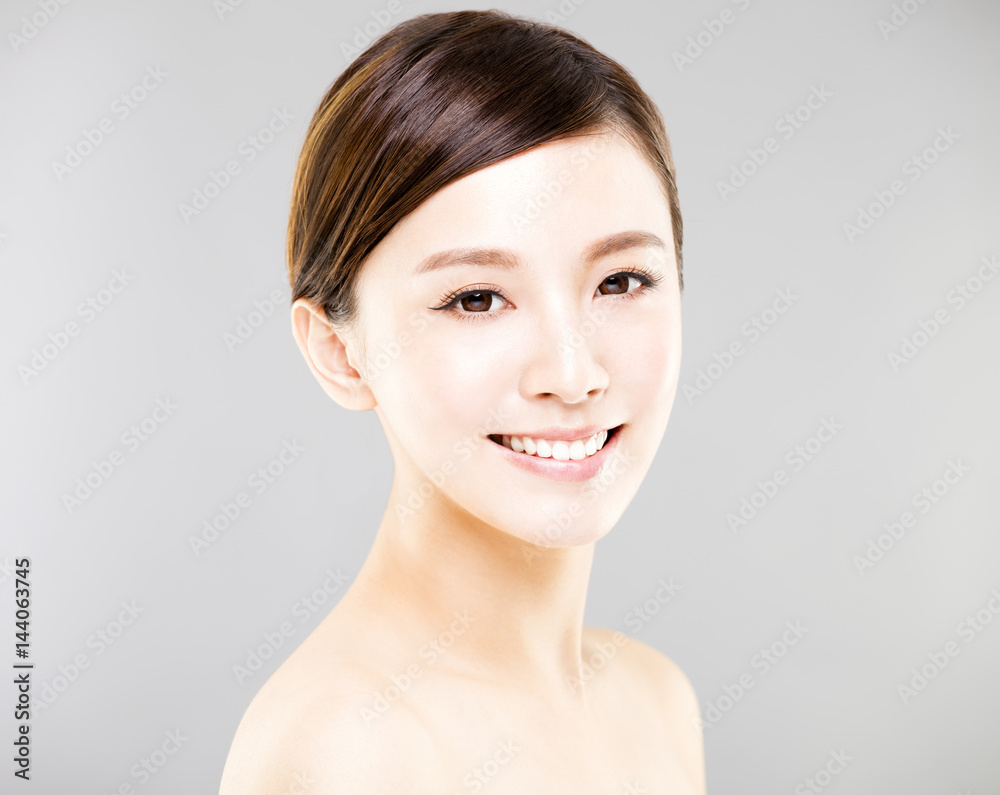 closeup young woman face with gray background closeup young woman face with gray background