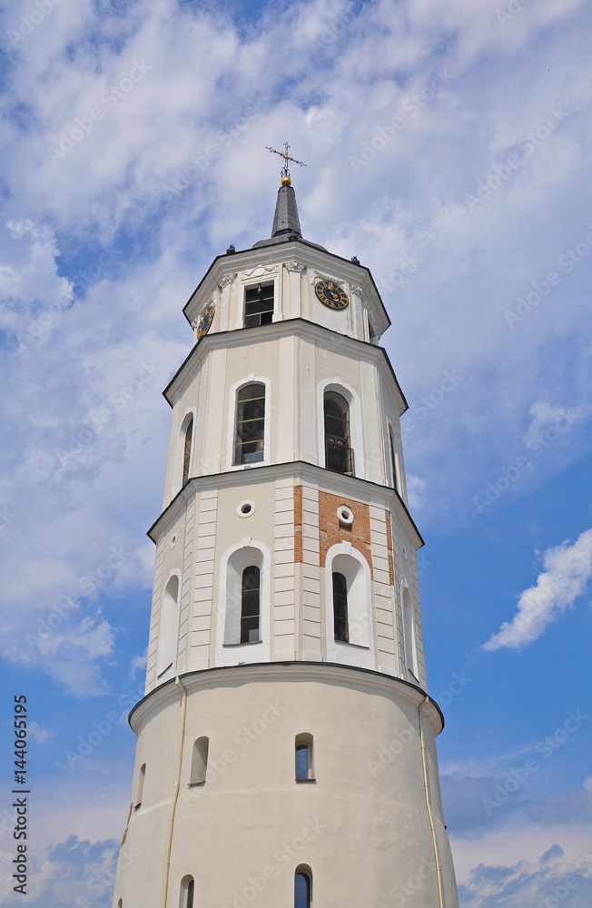 Snow-white bell tower in Vilnius on the background of blue sky