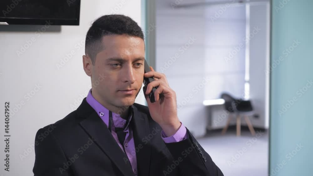 Portrait handsome businessman talking by phone. Receptionist give advice or consulting client about new services or products. Assistant wearing in elegant suit and shirt. Portrait handsome businessman talking by phone. Receptionist give advice or consulting client about new services or products. Assistant wearing in elegant suit and shirt.
