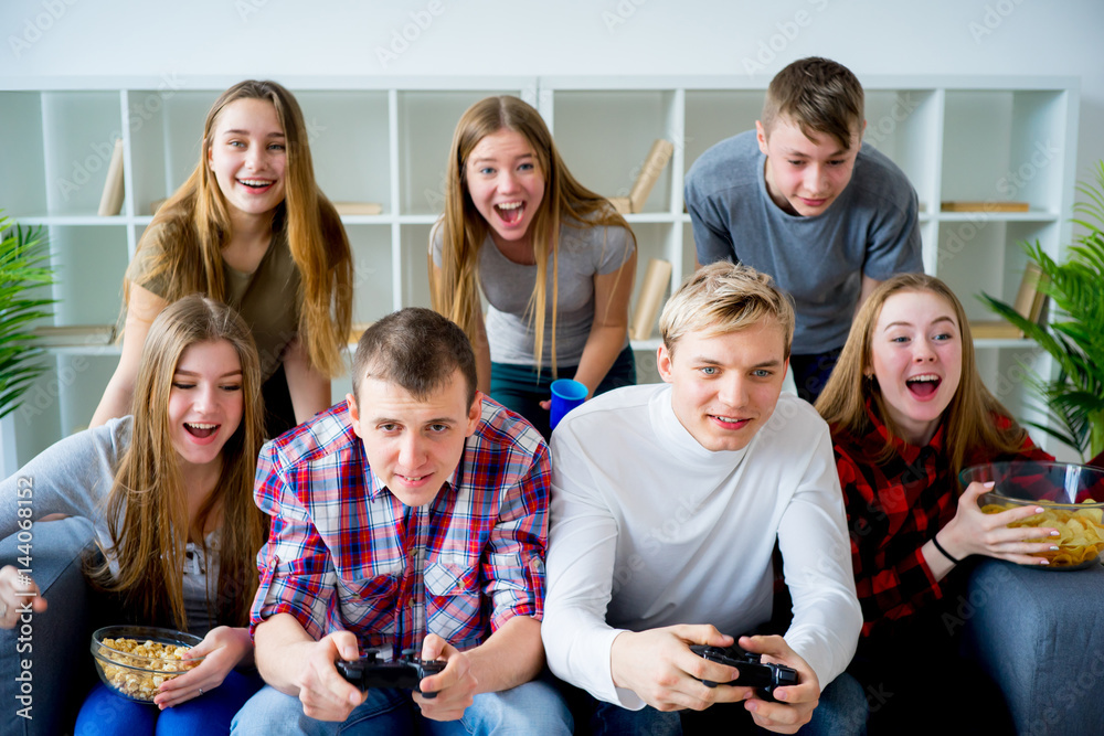 Friends playing a console game Friends playing a console game
