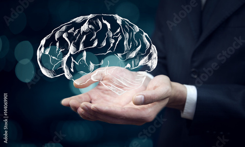 businessman hand brain in screen in bokeh background