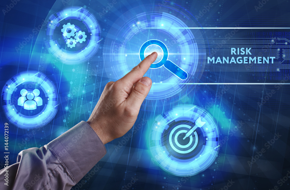 Business, Technology, Internet and network concept. Young businessman working on a virtual screen of the future and sees the inscription: Risk management Business, Technology, Internet and network concept. Young businessman working on a virtual screen of the future and sees the inscription: Risk management