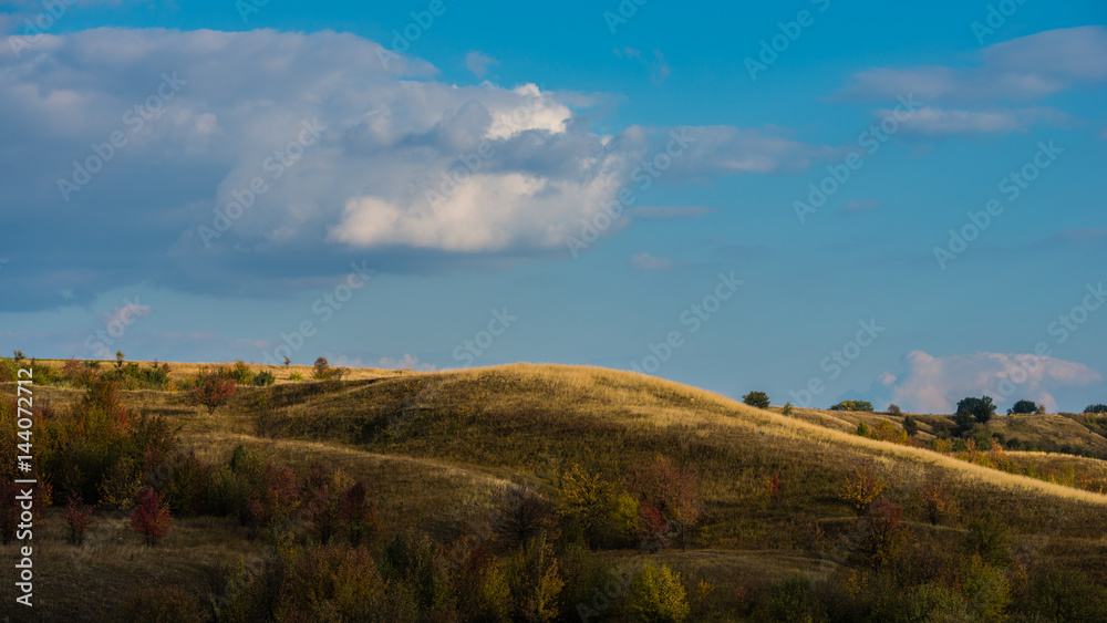 Landscape with dry feather grass in hilly terrain