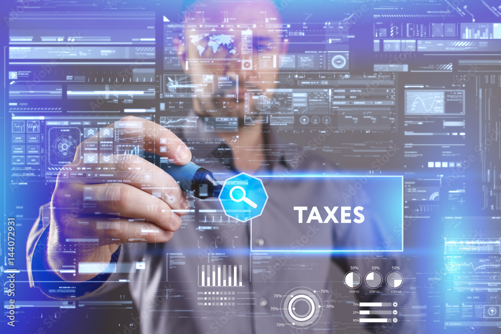 Business, Technology, Internet and network concept. Young businessman working on a virtual screen of the future and sees the inscription: Taxes Business, Technology, Internet and network concept. Young businessman working on a virtual screen of the future and sees the inscription: Taxes