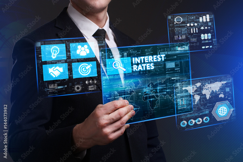Obraz premium Business, Technology, Internet and network concept. Young businessman working on a virtual screen of the future and sees the inscription: Interest rates