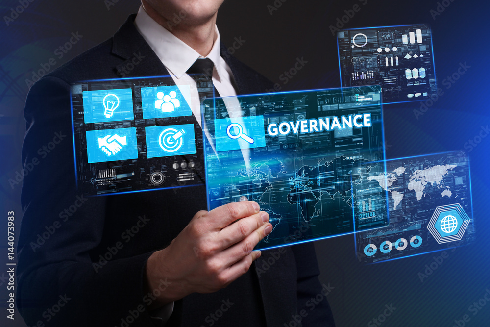 Business, Technology, Internet and network concept. Young businessman working on a virtual screen of the future and sees the inscription: Governance