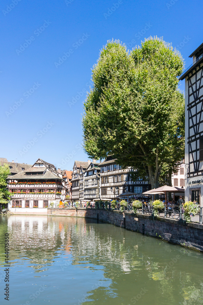Fototapeta premium STRASBOURG, FRANCE - August 23, 2016 : Street view of Traditional houses in Strasbourg, Alsace. is the official seat of the European Parliament, Located close to the border with Germany