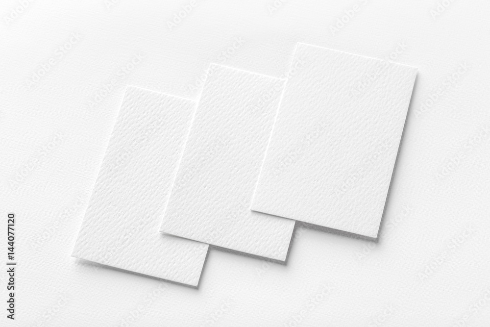 Mockup of three vertical business cards at white textured background. Mockup of three vertical business cards at white textured background.