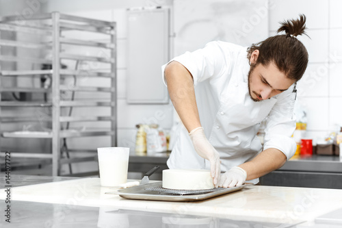 Professional chef preparing a cake