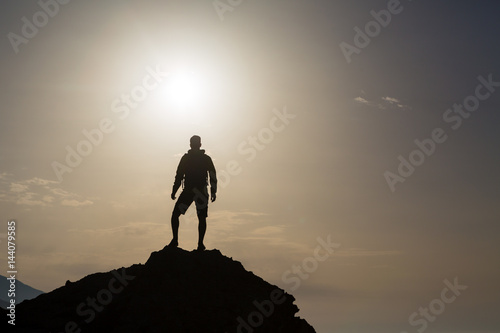 Man looking and celebrating sunrise and landscape