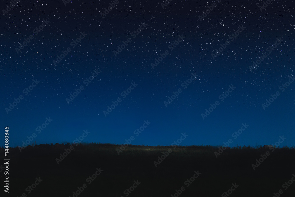 Photo of the night starry sky and horizon. Concept is stars in the sky