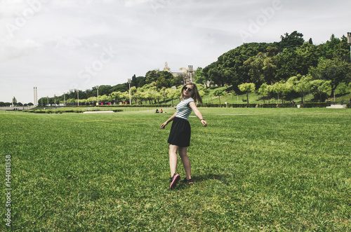young happy woman running and having fun on grass