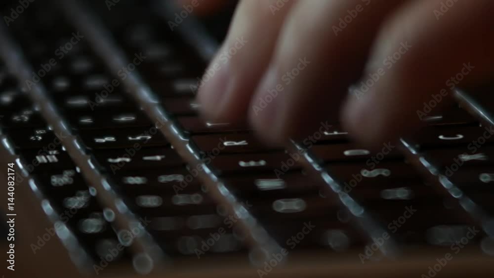 Typing on computer keyboard with illuminated buttons