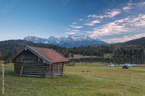 Wooden hut frames the alpine lake surrounded by the Alps, Geroldsee, Krun, Garmisch Partenkirchen, Upper Bavaria, Germany photo