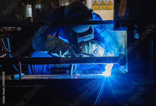 Welding steel structures and bright sparks in construction industry.