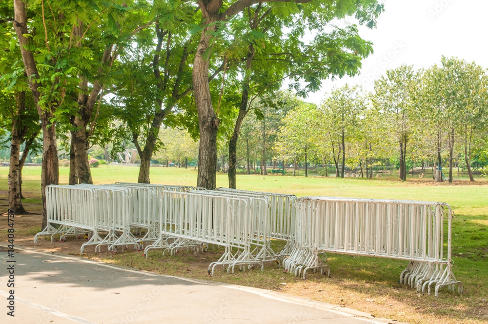 Many white fences in public park for security and private zone.