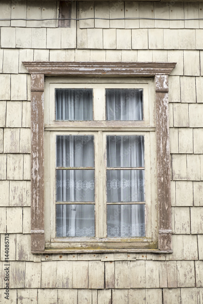 Distinctive wooden tiles around a window in Chiloe Island, Northern Patagonia, Chile Distinctive wooden tiles around a window in Chiloe Island, Northern Patagonia, Chile