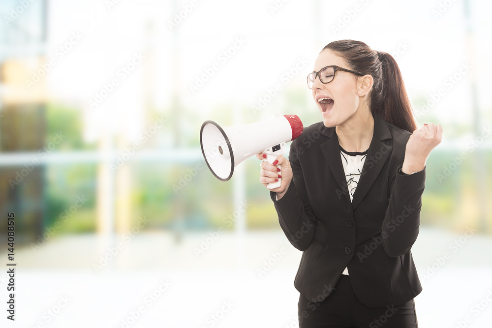 Young pretty businesswoman yelling over megaphone. Young pretty businesswoman yelling over megaphone.