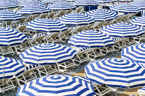 Blue and white beach parasols, Nice, Alpes Maritimes, Cote d'Azur, Provence, France, Mediterranean