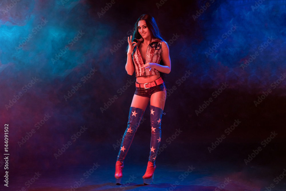 sexy young woman in erotic fetish wear dancing striptease in nightclub. Nude sexy woman in Show suit. sexy young woman in erotic fetish wear dancing striptease in nightclub. Nude sexy woman in Show suit.