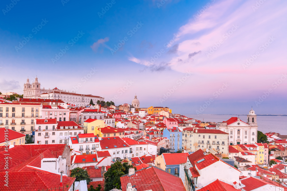 View of Alfama, the oldest district of the Old Town, with Monastery of Sao Vicente de Fora, Church of Saint Stephen and National Pantheon at scenic sunset, Lisbon, Portugal