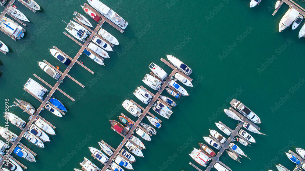 Obraz premium Pier speedboat. A marina lot. This is usually the most popular tourist attractions on the beach.Yacht and sailboat is moored at the quay.Aerial view by drone.Top view.